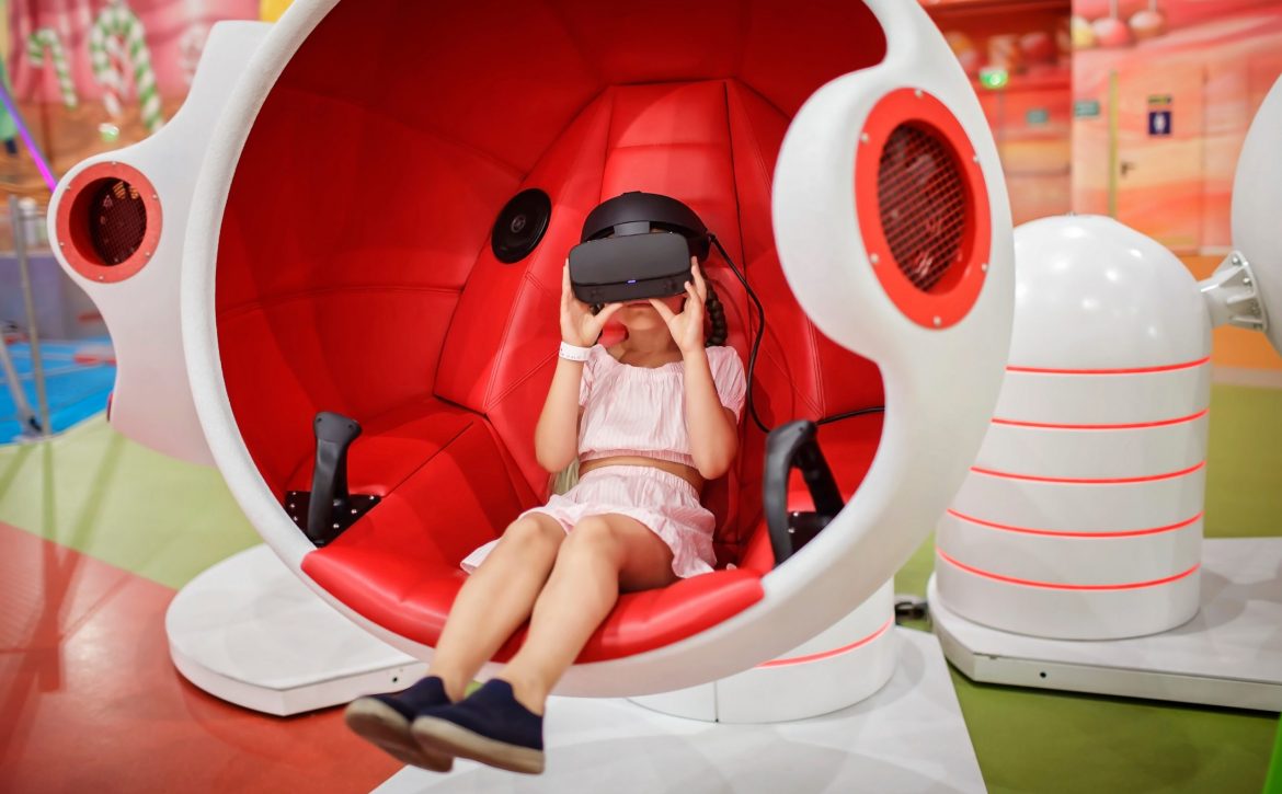 Girl wearing virtual reality googles and experiencing virtual re