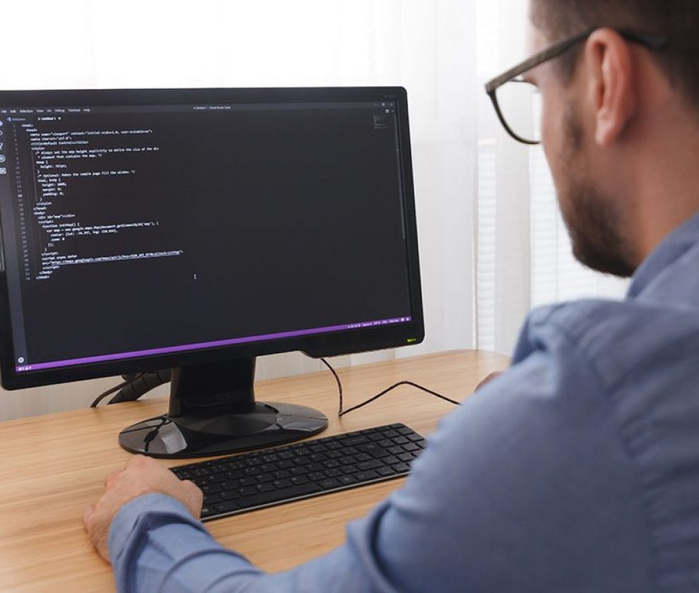 Programmer in Glsses Typing New Lines of HTML Code. Web Design Business and Web Development Concept. Freelance Work, LOS ANGELES, CALIFORNIA - 25.10.2019.